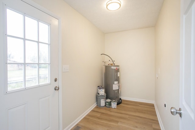 utility room featuring water heater