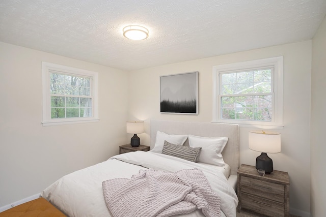 carpeted bedroom with a textured ceiling