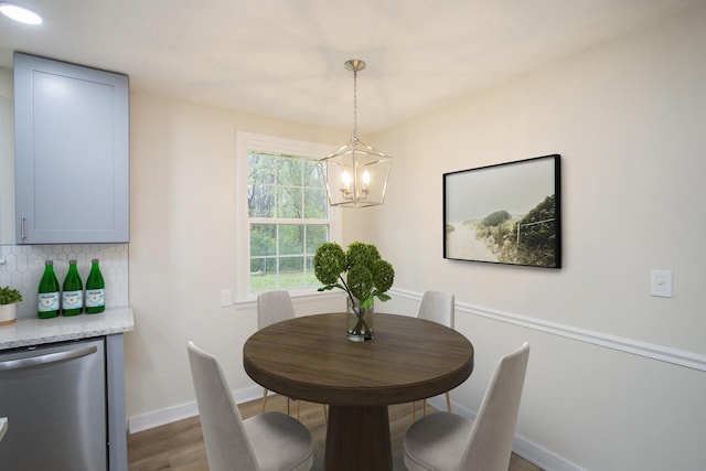 dining space featuring dark hardwood / wood-style flooring and an inviting chandelier