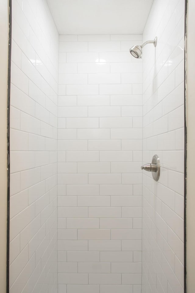 bathroom with tiled shower