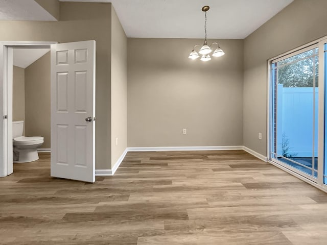 2002 Arum Ct, Spring Hill, TN 37174 - unfurnished dining area featuring a chandelier and light wood-style flooring
