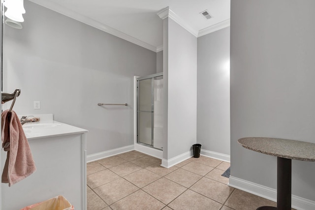 bathroom with tile patterned flooring, sink, a shower with door, and crown molding