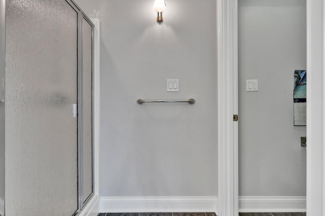 bathroom featuring a shower with shower door