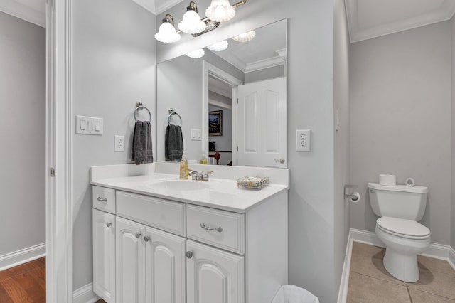 bathroom featuring tile patterned floors, vanity, toilet, and ornamental molding