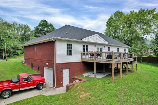 back of house with a garage, a yard, and a wooden deck