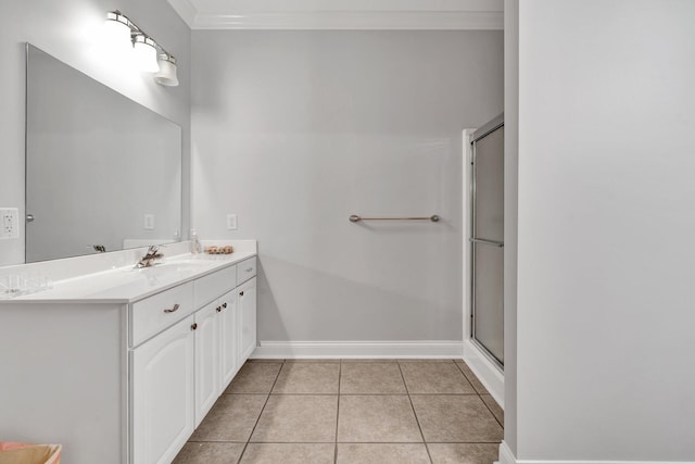 bathroom featuring vanity, tile patterned floors, a shower with door, and crown molding