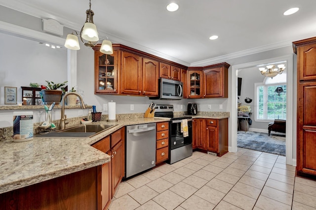 kitchen with sink, a chandelier, decorative light fixtures, appliances with stainless steel finishes, and ornamental molding