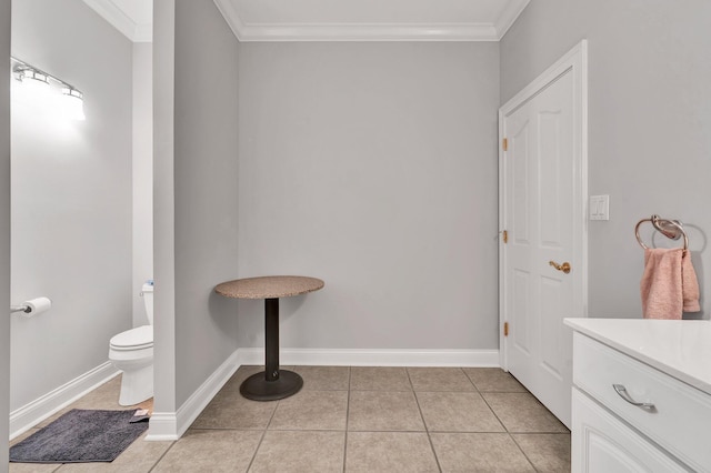 bathroom featuring tile patterned floors, toilet, and crown molding