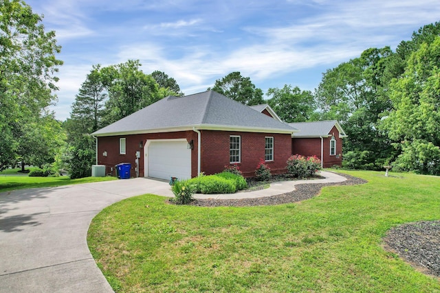 view of side of property with a yard and a garage