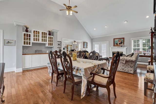 dining space with ceiling fan, light hardwood / wood-style floors, and ornamental molding