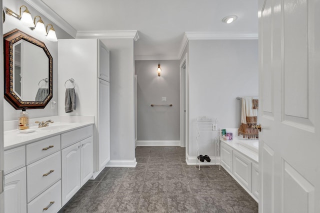 bathroom with vanity, crown molding, and a tub