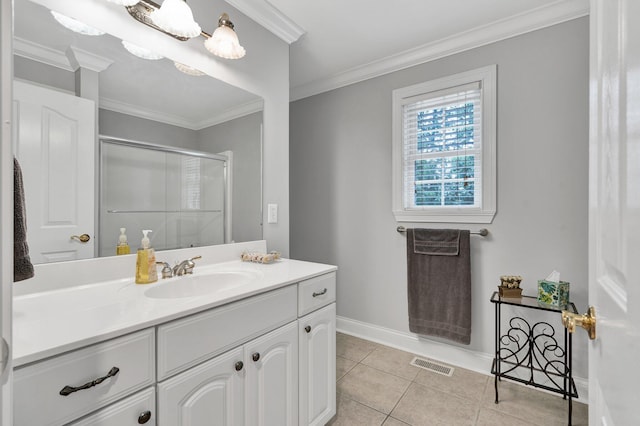 bathroom with tile patterned flooring, vanity, an enclosed shower, and crown molding