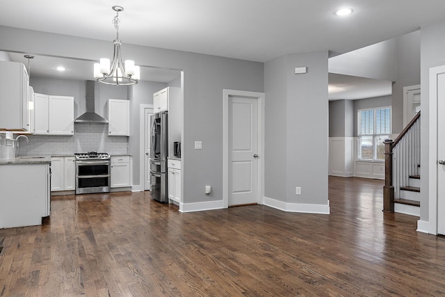 kitchen featuring white cabinetry, sink, wall chimney exhaust hood, stainless steel appliances, and dark hardwood / wood-style floors