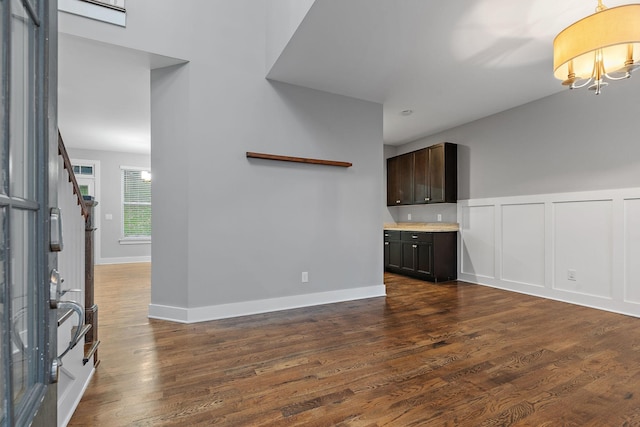 unfurnished living room with dark hardwood / wood-style flooring