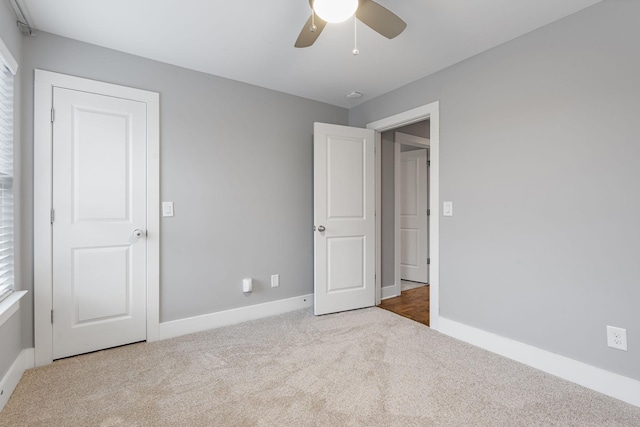 unfurnished bedroom with ceiling fan and light carpet