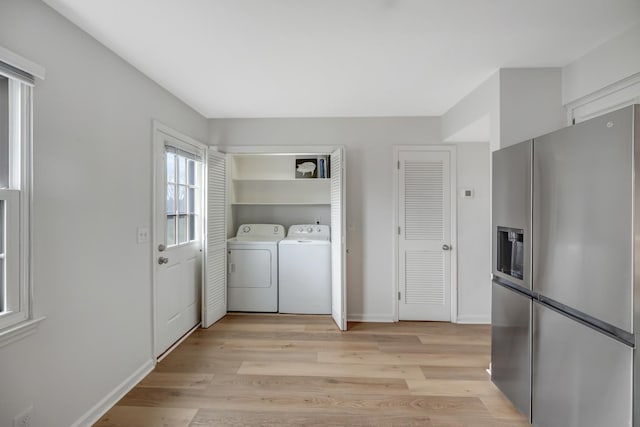 washroom featuring washer and clothes dryer and light hardwood / wood-style flooring