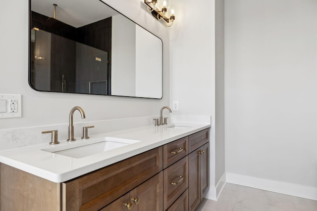 bathroom with double vanity, baseboards, and a sink