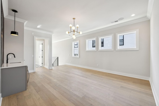 dining room featuring light wood finished floors, baseboards, visible vents, and ornamental molding