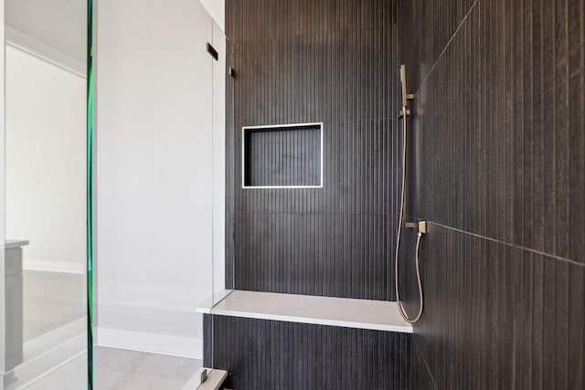 bathroom with a tile shower