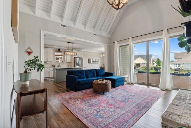 living room featuring beam ceiling, wooden ceiling, an inviting chandelier, dark hardwood / wood-style flooring, and high vaulted ceiling