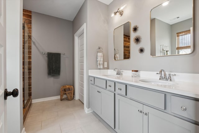 bathroom with tile patterned flooring, vanity, and walk in shower