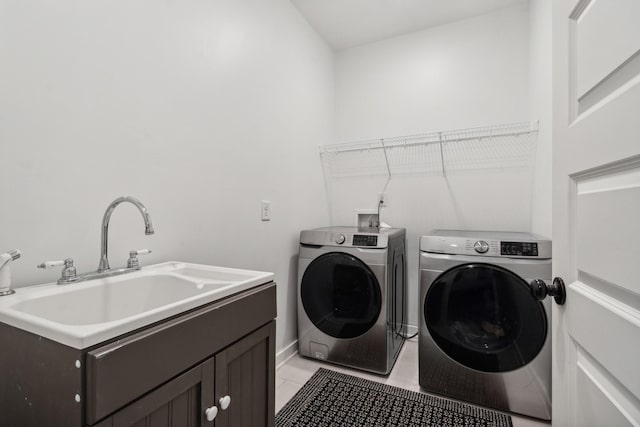 laundry room with washer and dryer, light tile patterned floors, and cabinets