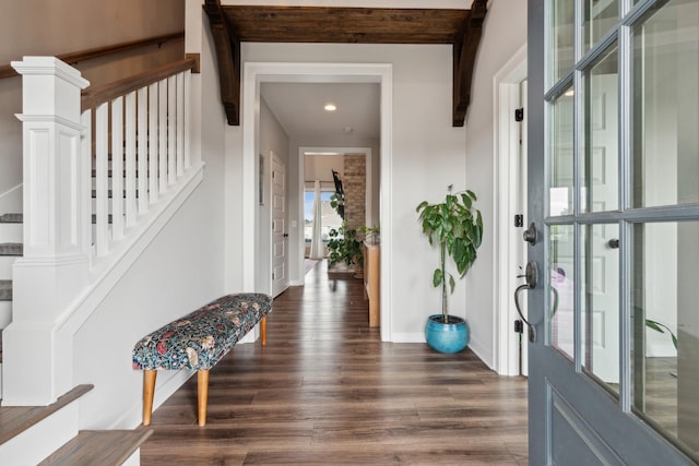 foyer entrance with beam ceiling and dark wood-type flooring