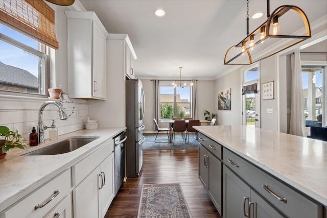 kitchen with gray cabinetry, sink, hanging light fixtures, dark hardwood / wood-style floors, and white cabinets