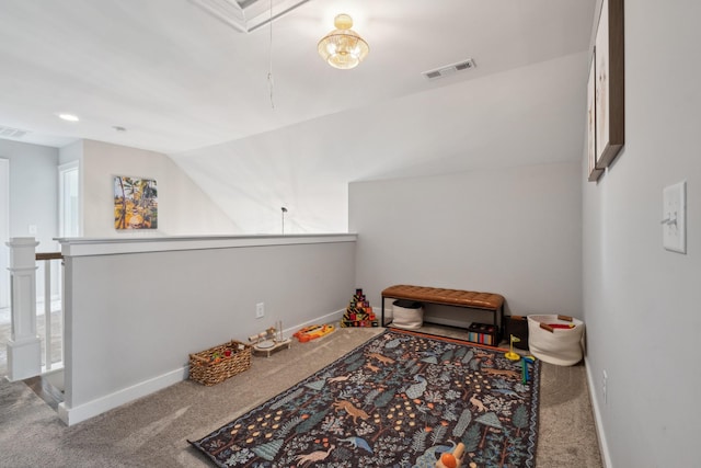 interior space featuring carpet floors and vaulted ceiling