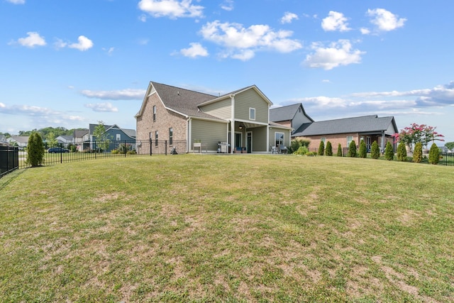 rear view of house with a lawn