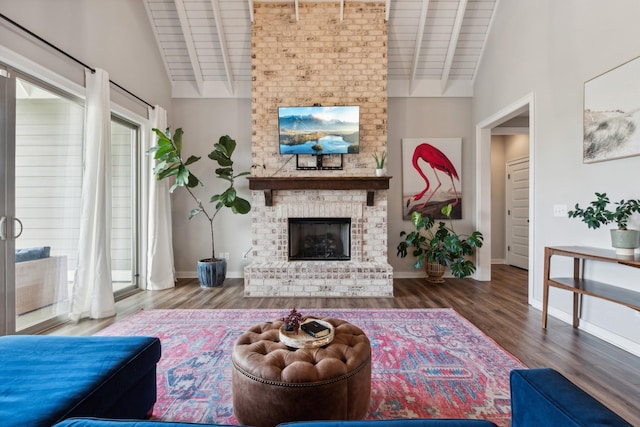 living room featuring dark wood-type flooring, high vaulted ceiling, a brick fireplace, beamed ceiling, and wood ceiling