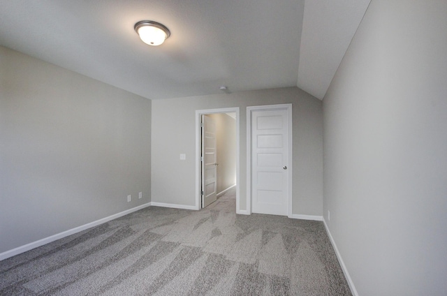 interior space with light colored carpet and lofted ceiling