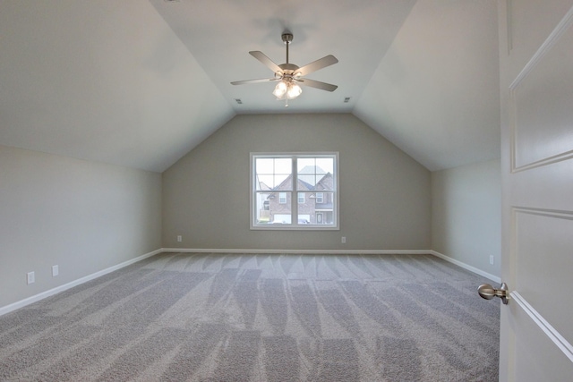 bonus room with ceiling fan, light colored carpet, and vaulted ceiling