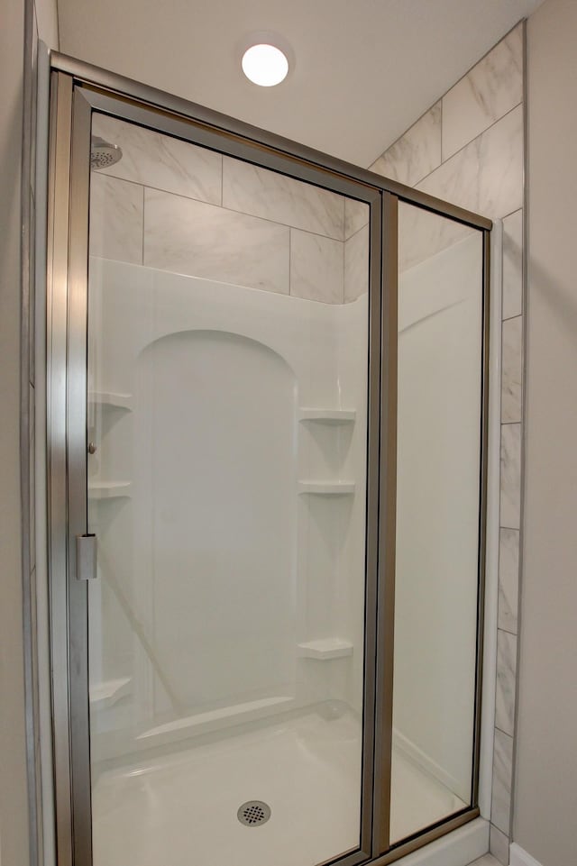 bathroom with a shower with shower door