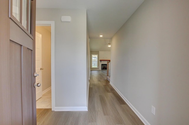 corridor with light hardwood / wood-style floors