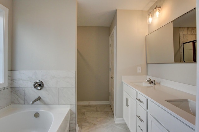 bathroom with vanity and a bath