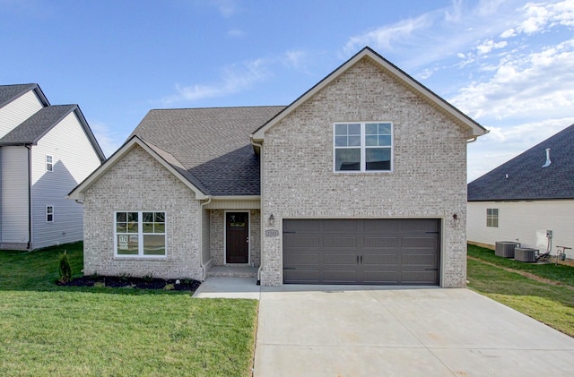 view of front of house featuring a garage, a front lawn, and cooling unit