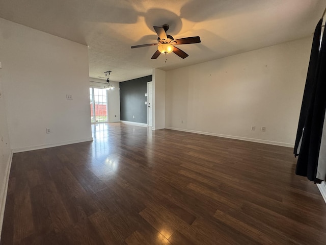 empty room with ceiling fan and dark hardwood / wood-style floors