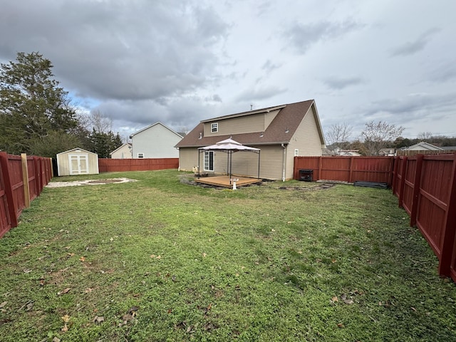 view of yard with a gazebo, a shed, and a wooden deck