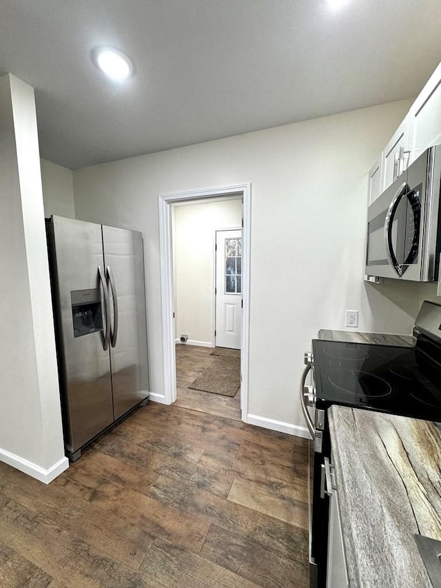 kitchen featuring white cabinets, dark hardwood / wood-style floors, and appliances with stainless steel finishes