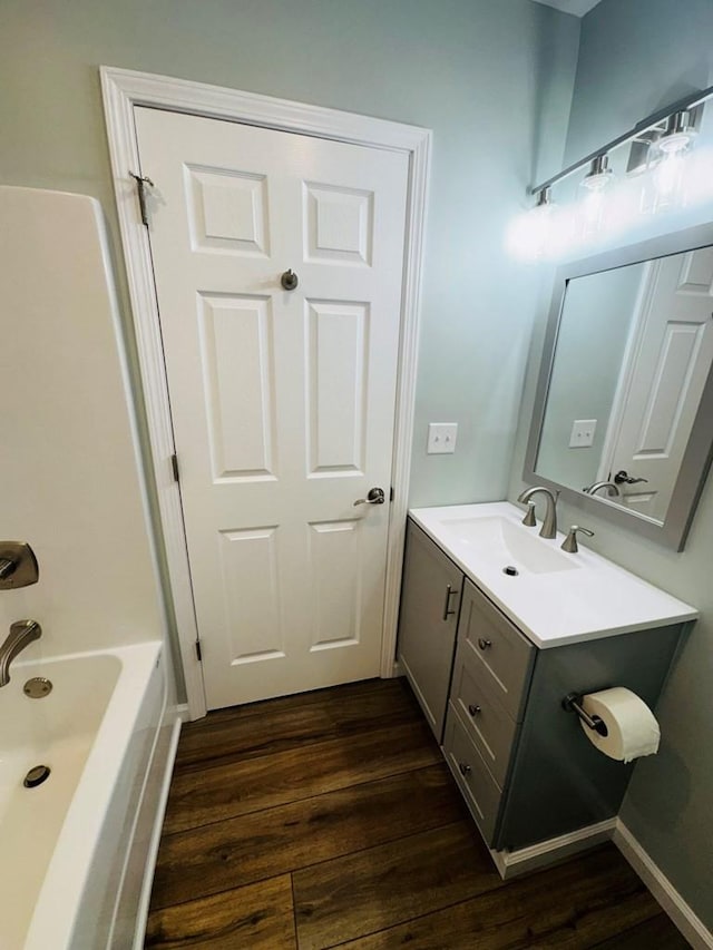 bathroom with wood-type flooring, vanity, and shower / bath combination