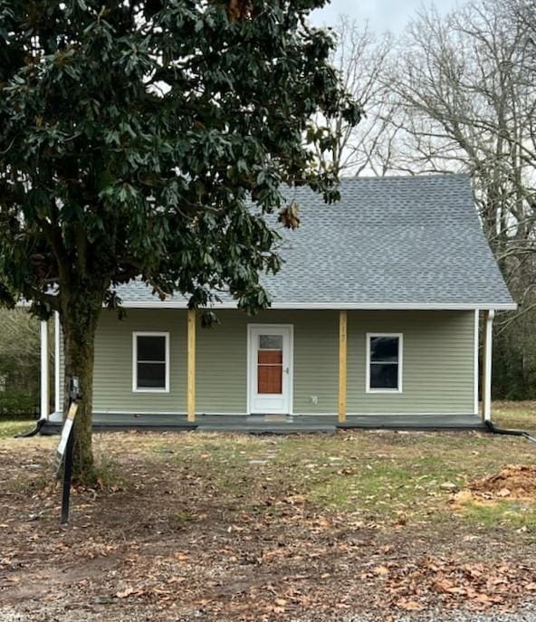 view of front of home featuring covered porch and roof with shingles