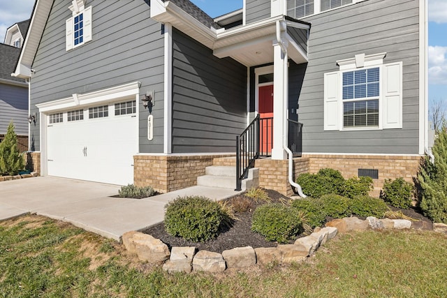 view of exterior entry with a garage