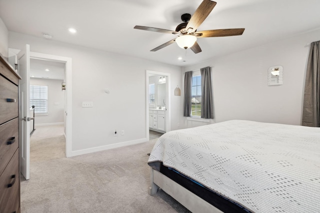 carpeted bedroom with connected bathroom and ceiling fan