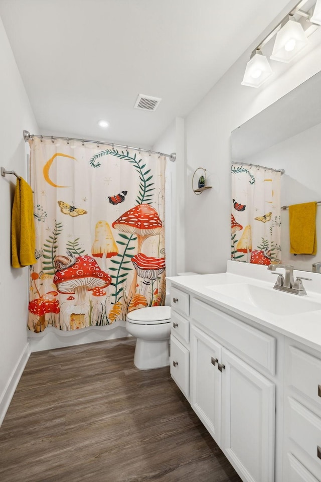 bathroom featuring hardwood / wood-style flooring, vanity, and toilet