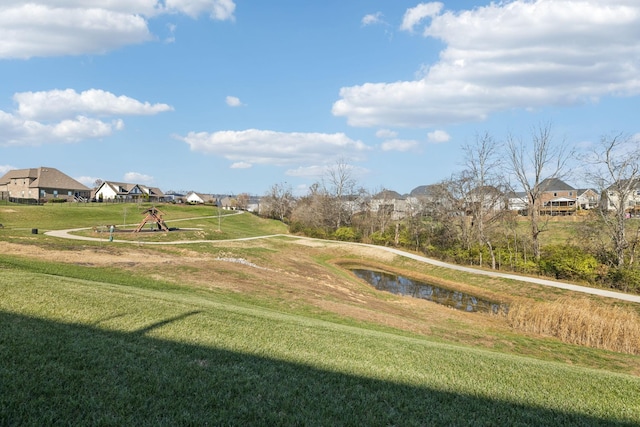 view of community featuring a playground and a yard