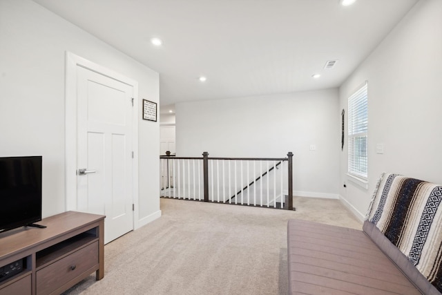 sitting room featuring light colored carpet