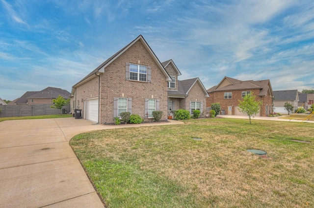 view of front of property with a front yard and a garage