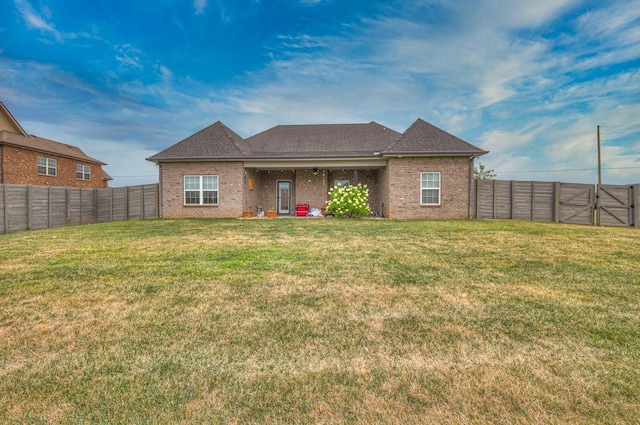 back of house with a yard