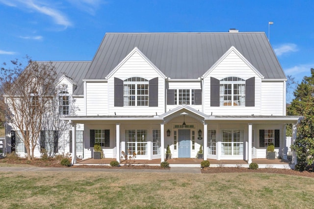 view of front facade with covered porch and a front yard